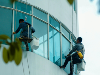 Specialist Cleaning - two men on high ropes cleaning windows - Window & High Level Cleaning