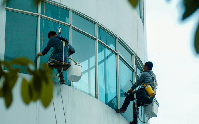 Specialist Cleaning - two men on high ropes cleaning windows - Window & High Level Cleaning